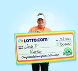 Winner Corina D. holds a check for $100,000 in her hands